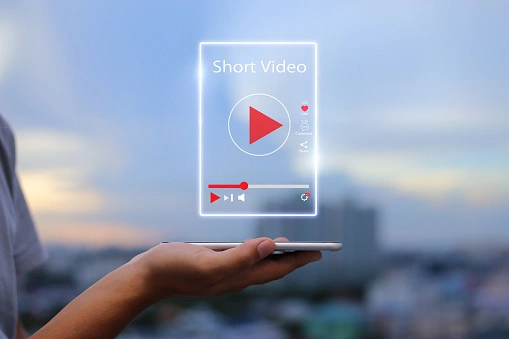A person holding a mobile in hand which shows the short video represntation with video screen